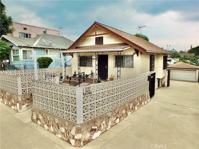 view of front of property featuring an outbuilding and a garage