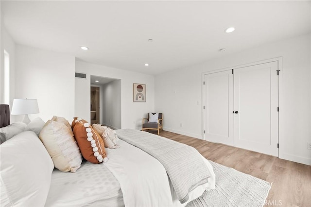 bedroom featuring light hardwood / wood-style floors and a closet