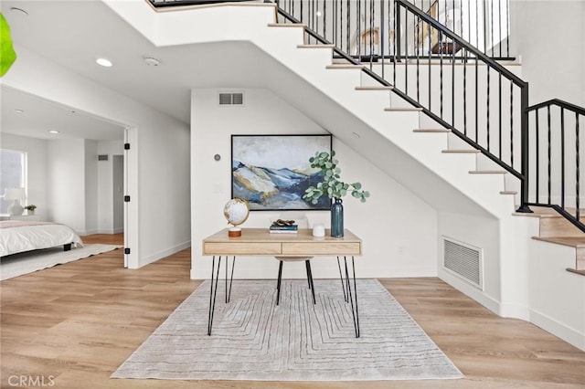 stairway featuring hardwood / wood-style floors