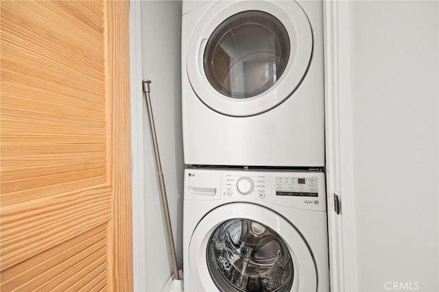 laundry room with stacked washer / drying machine