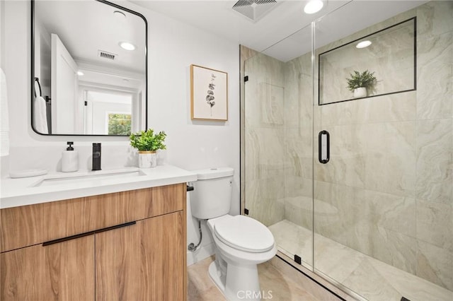 bathroom featuring vanity, an enclosed shower, and toilet