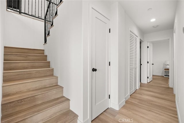 staircase featuring wood-type flooring