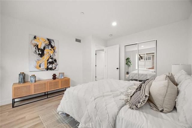 bedroom featuring a closet and light hardwood / wood-style flooring