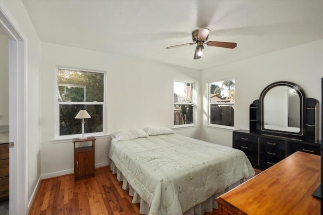 bedroom with ceiling fan and hardwood / wood-style flooring