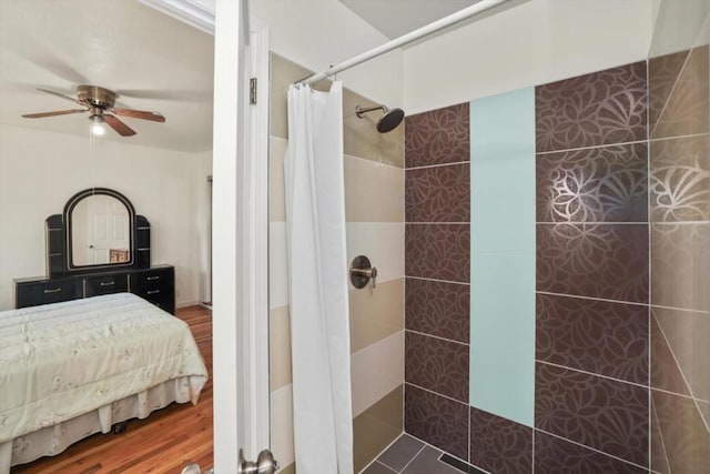 bathroom featuring ceiling fan, a shower with shower curtain, and hardwood / wood-style floors