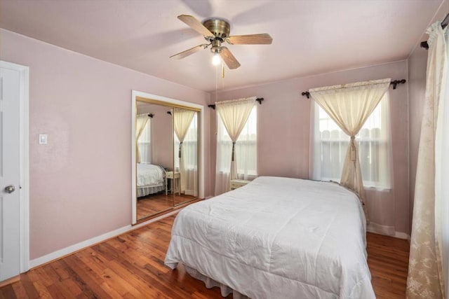 bedroom featuring hardwood / wood-style flooring, ceiling fan, and a closet