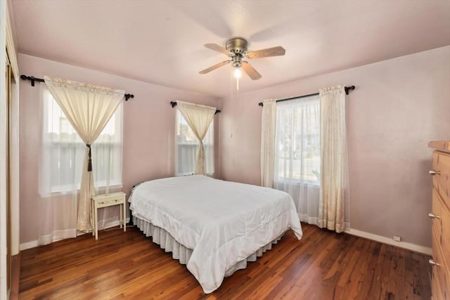 bedroom with ceiling fan and dark hardwood / wood-style floors