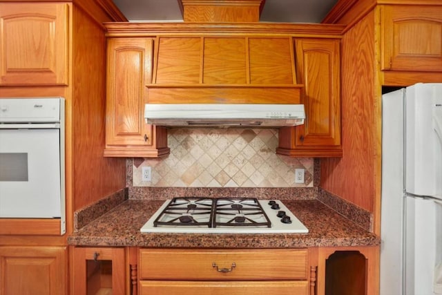 kitchen with white appliances and backsplash