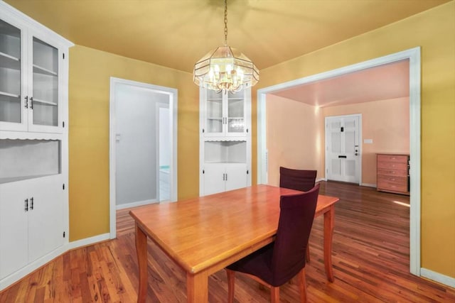 dining room featuring dark hardwood / wood-style flooring and a chandelier