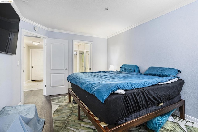 bedroom with wood-type flooring and crown molding