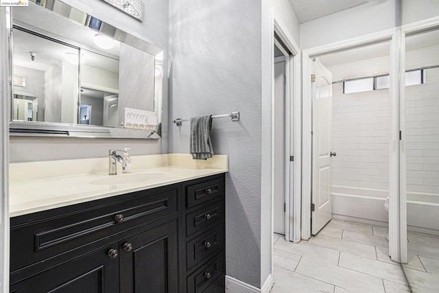 bathroom with vanity, tiled shower / bath combo, and tile patterned floors