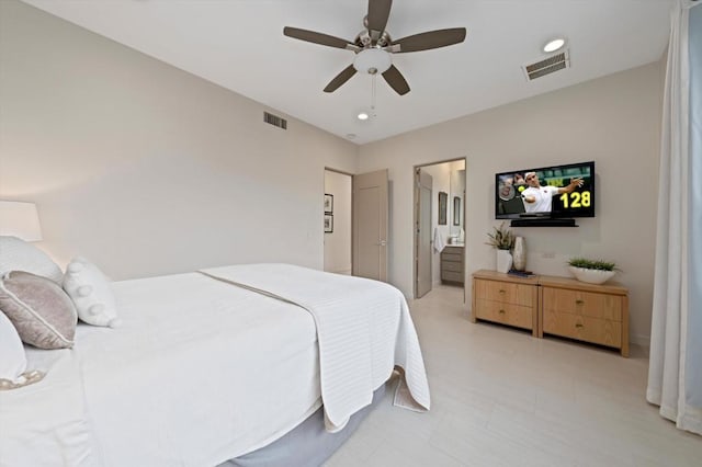 bedroom with ceiling fan and ensuite bath