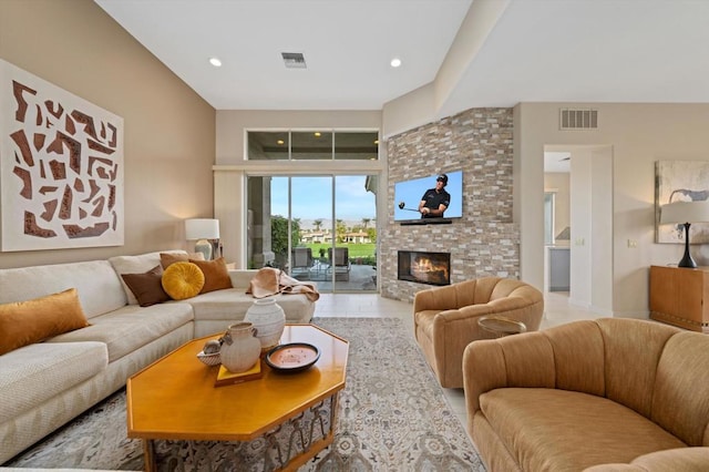 living room featuring a stone fireplace and light tile patterned flooring