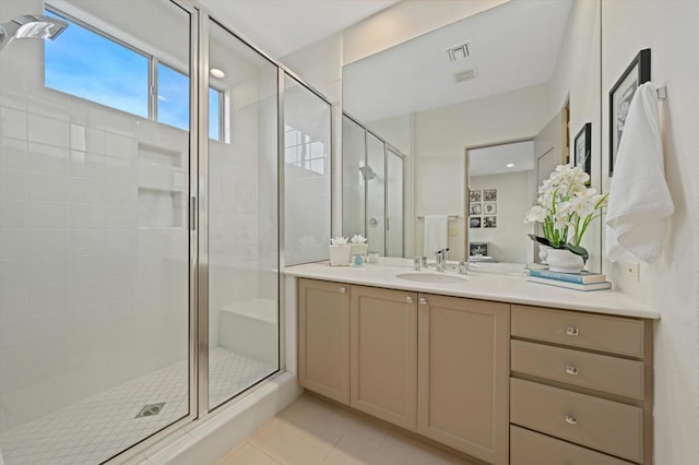 bathroom with an enclosed shower, vanity, and tile patterned floors