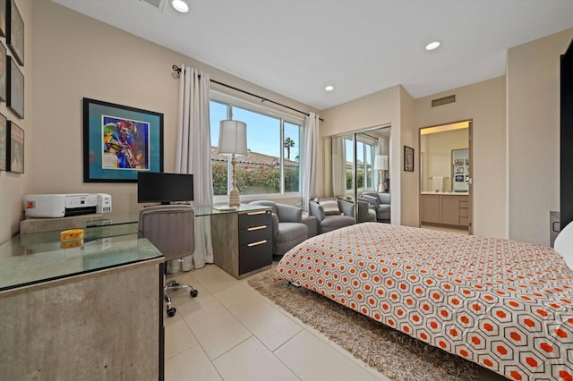 bedroom with light tile patterned floors and ensuite bath