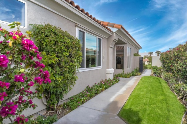 view of home's exterior featuring a lawn