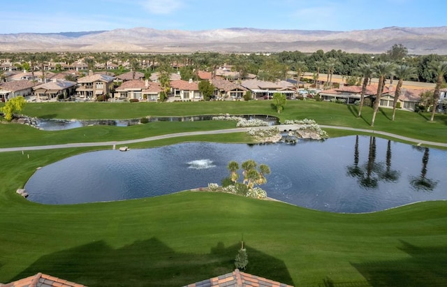 view of community featuring a yard and a water and mountain view