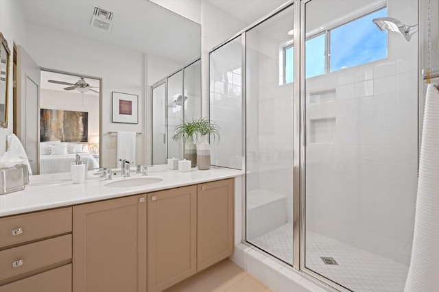 bathroom featuring tile patterned flooring, vanity, ceiling fan, and a shower with shower door