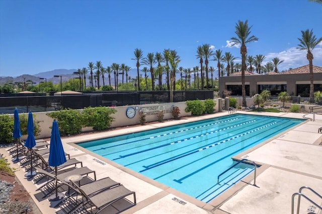 view of swimming pool featuring a mountain view and a patio area