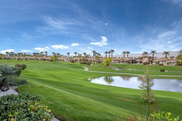 view of home's community featuring a lawn and a water view