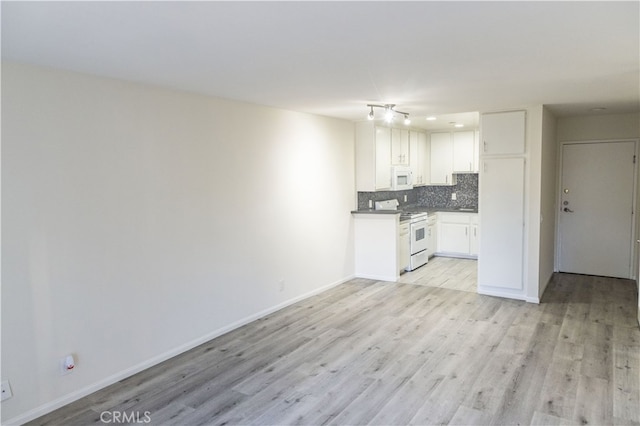 kitchen featuring white cabinetry, white appliances, light hardwood / wood-style flooring, and tasteful backsplash