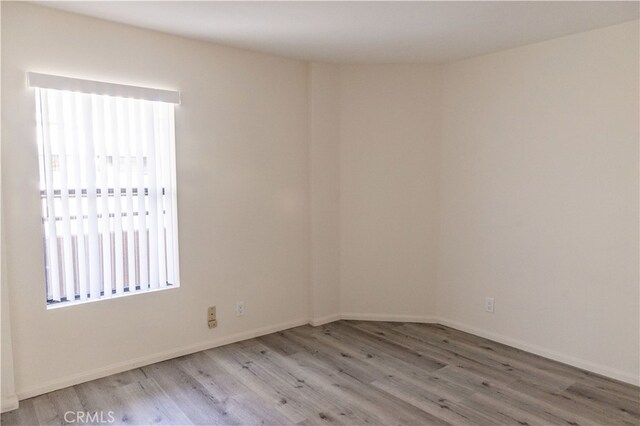 unfurnished room with wood-type flooring