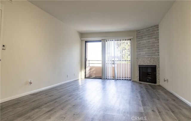 unfurnished living room featuring hardwood / wood-style floors and a fireplace