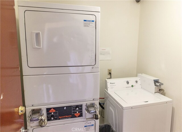 laundry area featuring stacked washer / dryer