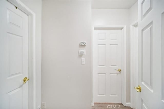 corridor with light hardwood / wood-style flooring