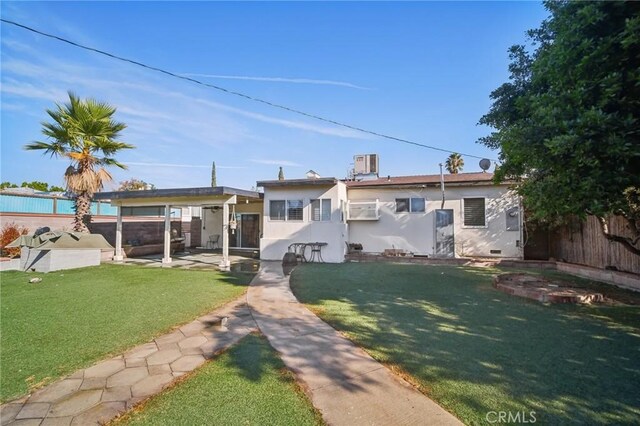 view of front facade with a front yard and a patio area