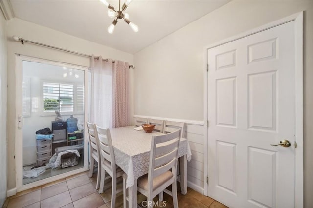 dining space with a chandelier and light tile patterned floors