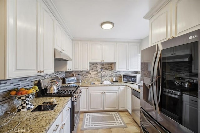 kitchen featuring appliances with stainless steel finishes, tasteful backsplash, white cabinetry, and sink