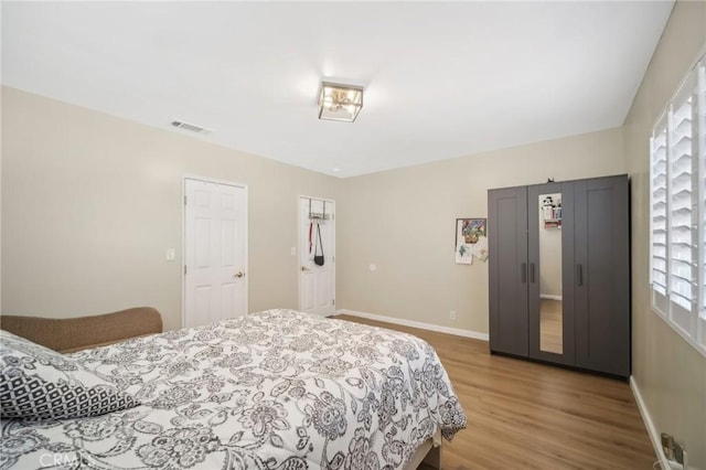 bedroom with hardwood / wood-style floors