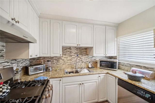 kitchen featuring decorative backsplash, appliances with stainless steel finishes, white cabinetry, and sink