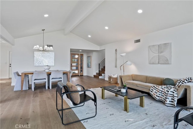 living room featuring stairway, wood finished floors, vaulted ceiling with beams, recessed lighting, and a notable chandelier