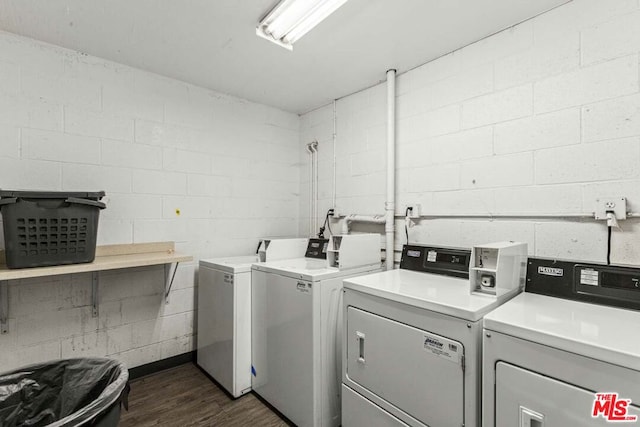 laundry area with washer and dryer and dark wood-type flooring