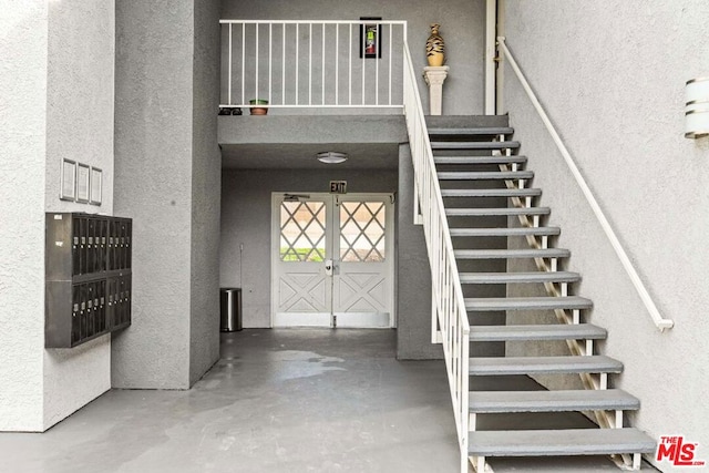 stairs with concrete flooring