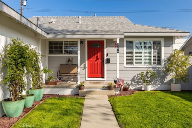 entrance to property with a lawn