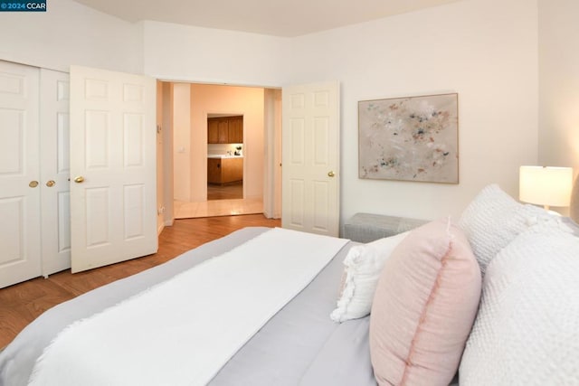 bedroom featuring wood-type flooring and a closet