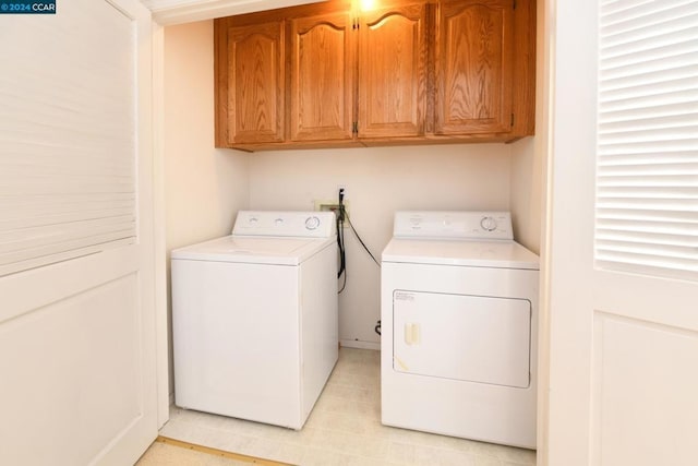 washroom featuring cabinets and independent washer and dryer