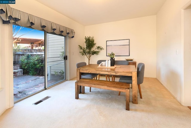 carpeted dining room featuring a wealth of natural light