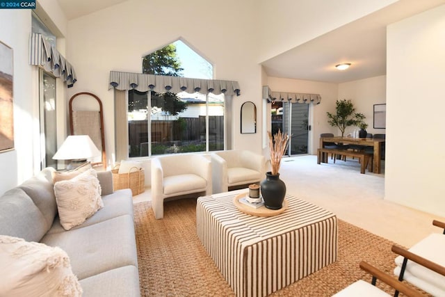 living room with carpet floors and high vaulted ceiling