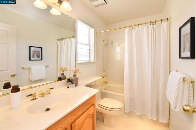 bathroom featuring toilet, vanity, and tile patterned flooring