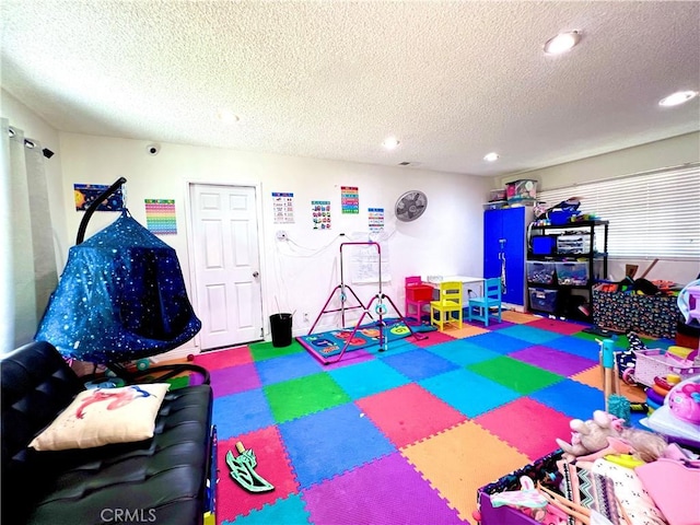 game room with a textured ceiling