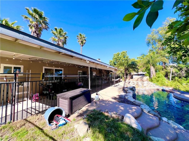 exterior space with a patio area and a fenced in pool