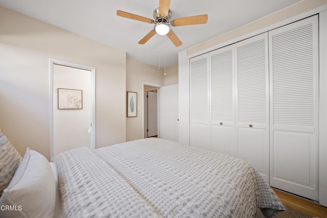 bedroom featuring ceiling fan, wood-type flooring, and a closet