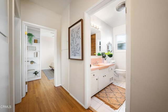 bathroom with hardwood / wood-style floors, vanity, and toilet