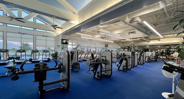 gym featuring ceiling fan and high vaulted ceiling