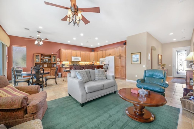 living room featuring ceiling fan and light tile patterned floors