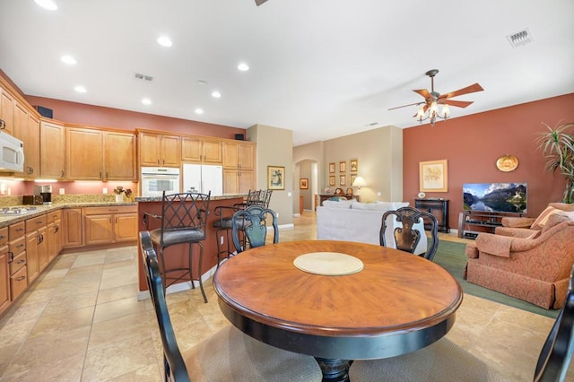 dining space featuring ceiling fan and light tile patterned floors